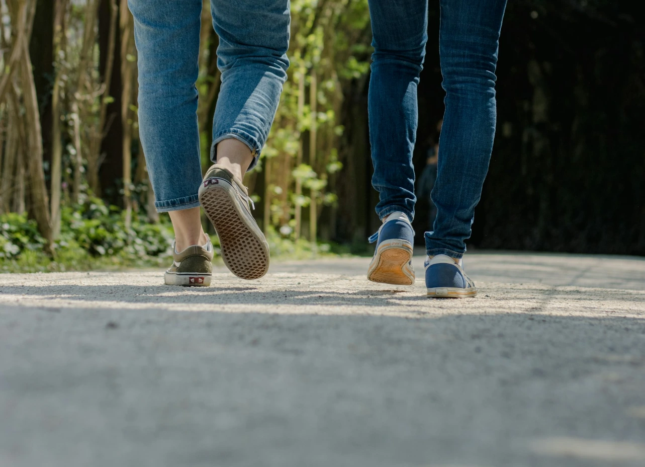 a couple of people walking down a street